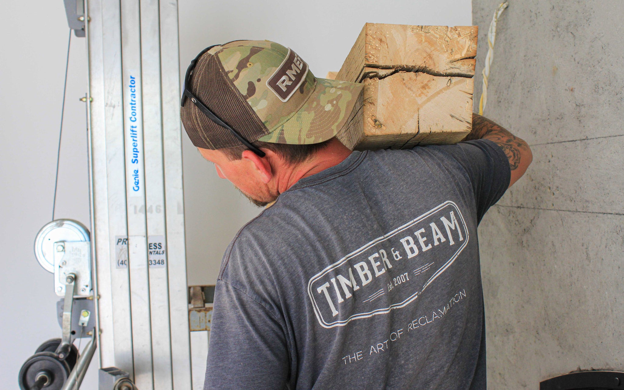 Timber & Beam team member carrying a box beam at a jobsite